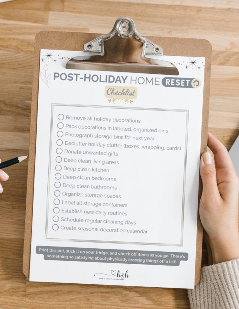 Your Complete Post-Holiday Home Reset Guide 8 A person holding a clipboard with a printed checklist for a post-holiday home reset, including tasks like decluttering and deep cleaning.