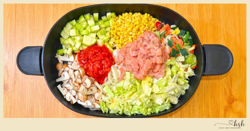 Colorful raw ingredients including chicken, corn, and cabbage prepped for healthy and easy January slow cooker recipes.