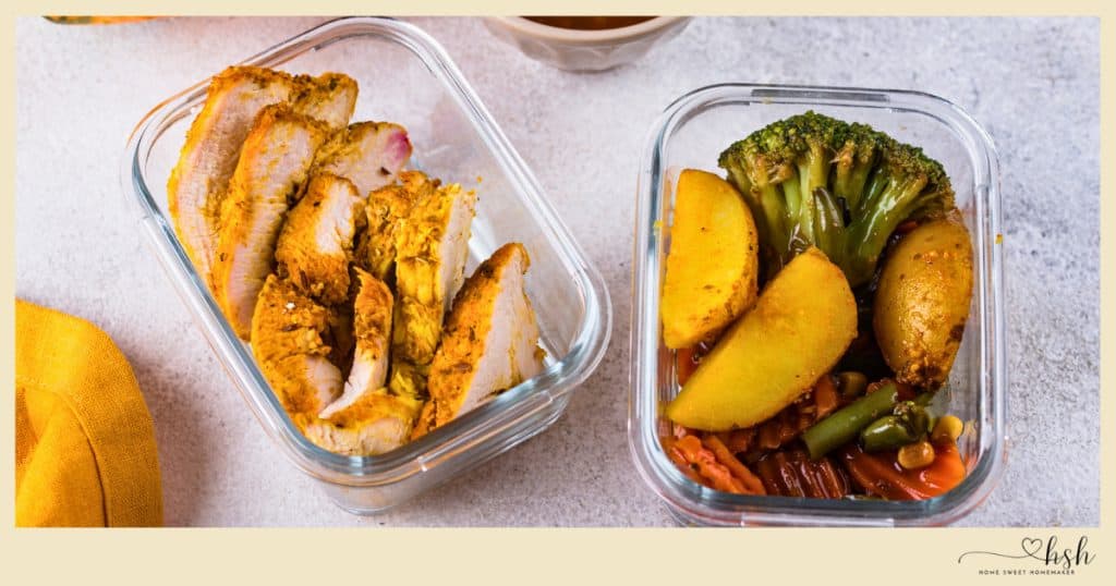 Glass meal prep containers filled with seasoned chicken and vegetables, perfect for easy January slow cooker recipes.
