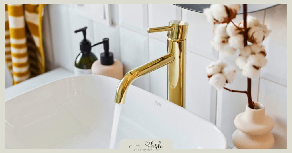Elegant gold bathroom faucet with minimalist white sink showing upgraded fixtures for home resolutions for new year refreshes.