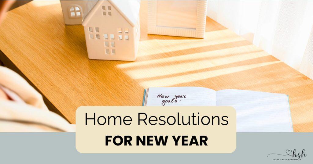 Desktop scene with decorative house model and goal-setting notebook for planning home resolutions for new year successfully.