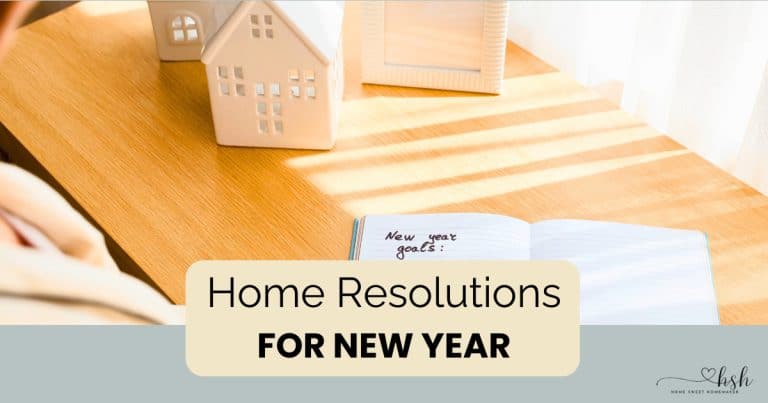 Desktop scene with decorative house model and goal-setting notebook for planning home resolutions for new year successfully.