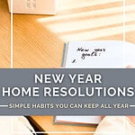 Miniature wooden house model beside open notebook with pen showing planning for home resolutions for new year.
