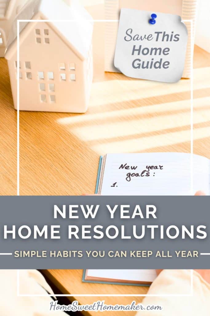 Miniature wooden house model beside open notebook with pen showing planning for home resolutions for new year.
