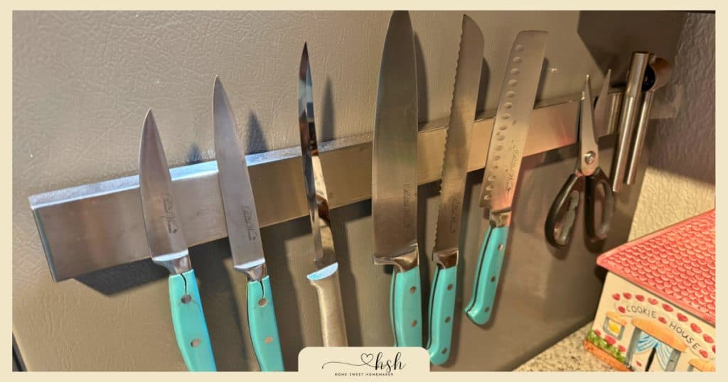 How to Organize a Small Kitchen on a Budget | Complete Guide 5 Magnetic knife strip mounted on wall displaying various kitchen knives organized vertically to save counter and drawer space in small kitchen.