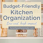 Organized kitchen shelving with clear glass storage containers holding dry goods and white dining chairs showing budget-friendly small kitchen organization ideas.