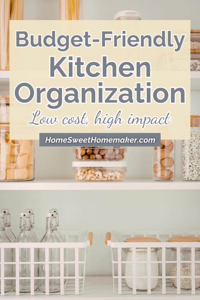How to Organize a Small Kitchen on a Budget | Complete Guide 11 Organized kitchen shelving with clear glass storage containers holding dry goods and white dining chairs showing budget-friendly small kitchen organization ideas.
