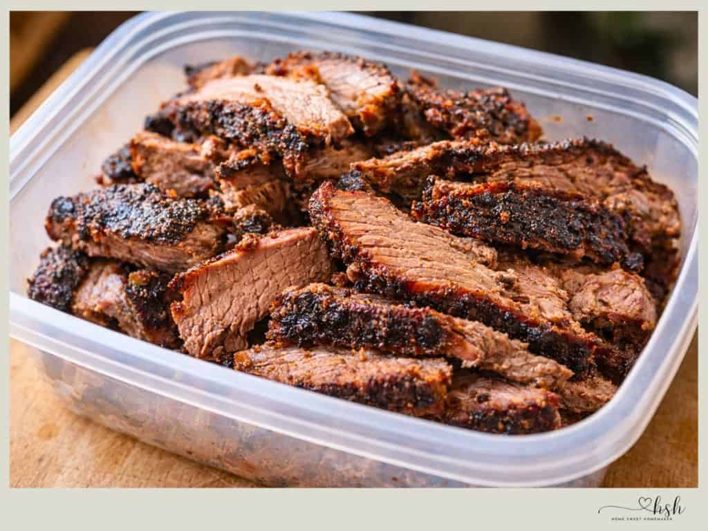 Leftover Beef Brisket Recipes That Turn Yesterday’s Dinner Into Something New 2 Sliced leftover beef brisket with dark bark stored in clear container ready for creative recipes